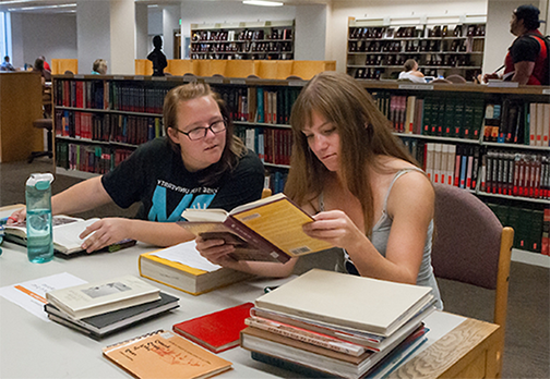 Students going through books together